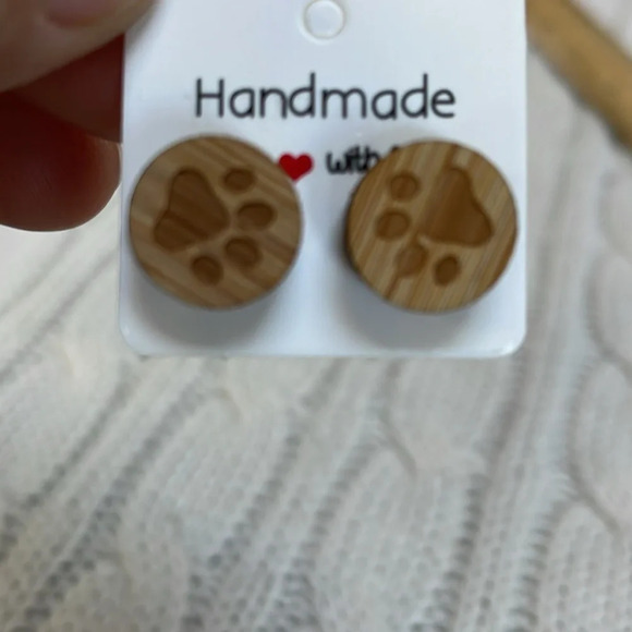 Jewelry - Earrings. Wooden paw prints. .5”. Steel post/backs. Circular Wood grain Handmade